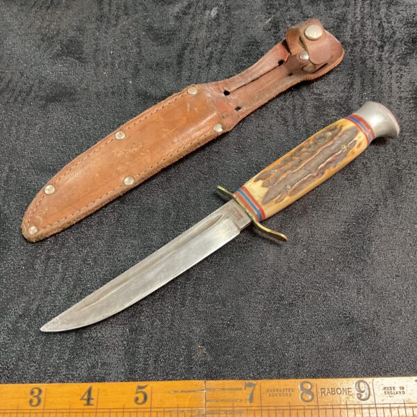 Vintage German Rocca knife with horn handle and leather sheath.