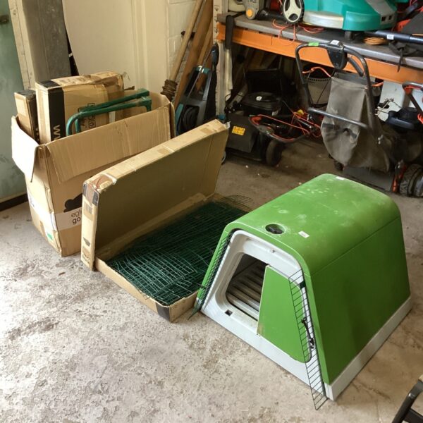 Used Omlet Eglu Go mobile chicken house and pen in a garden setting.