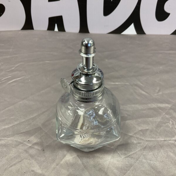 Clear glass vintage oil lamp with metal burner.