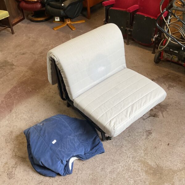 Compact chair bed with cover, ideal for small spaces.