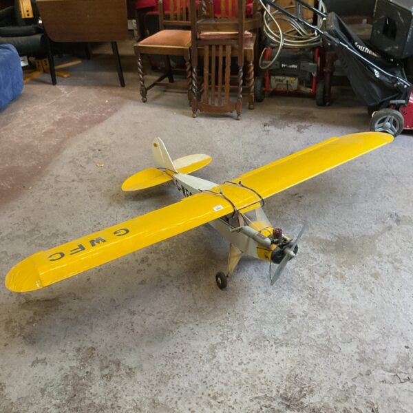 Large yellow remote control RC airplane model.