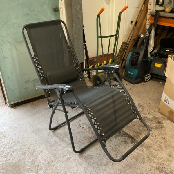 Black garden recliner chair for outdoor use.