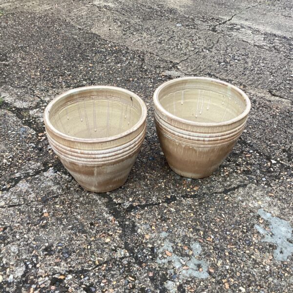 Pair of warm-toned glazed garden pots for outdoor plants.