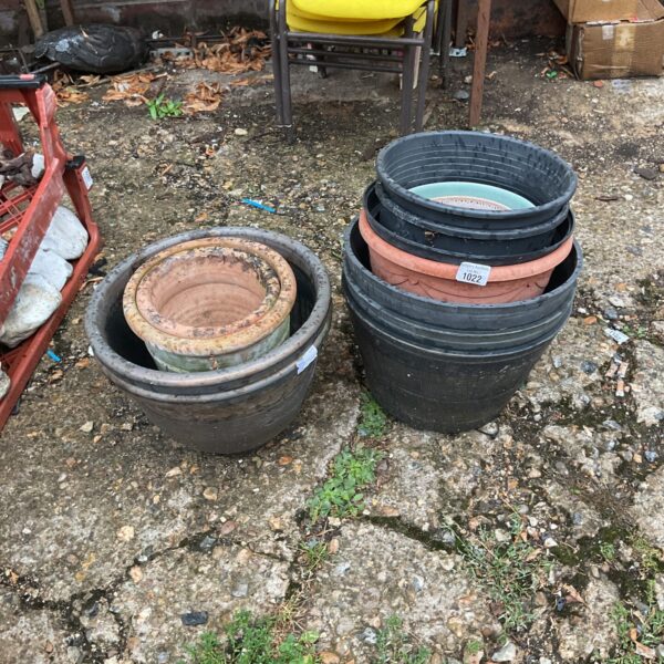 Lot of three weathered terracotta garden pots for outdoor planting.