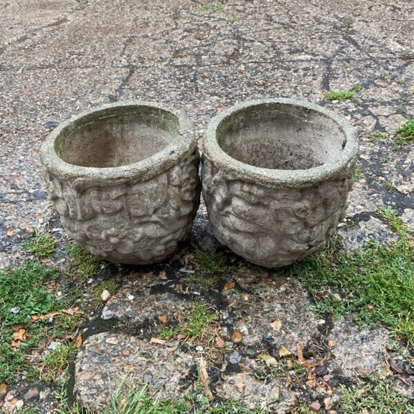 Weathered stone garden planters adding rustic charm to outdoor spaces.