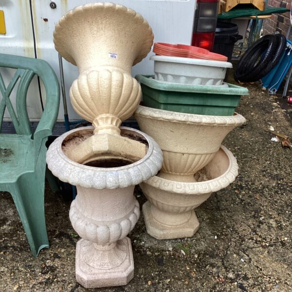 Lot of ribbed plastic garden planters for outdoor use.