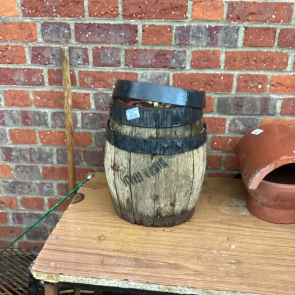 Small wooden garden barrel, rustic outdoor decoration.