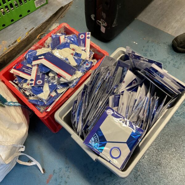 Two boxes of Rangers FC branded football balloons for parties.