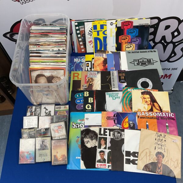 Vintage 7” vinyl singles and cassette tapes collection, 1980s music.