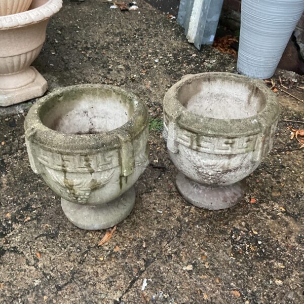 Weathered stone garden plant pots for outdoor display.