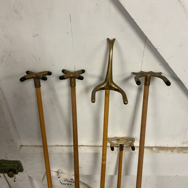 Antique set of five snooker bridges with brass rests.