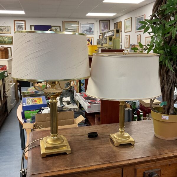Vintage brass table lamps with cream shades, a classic lighting pair.