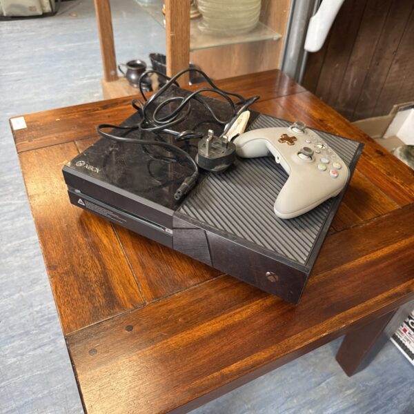 Microsoft Xbox One console with controller and power lead.