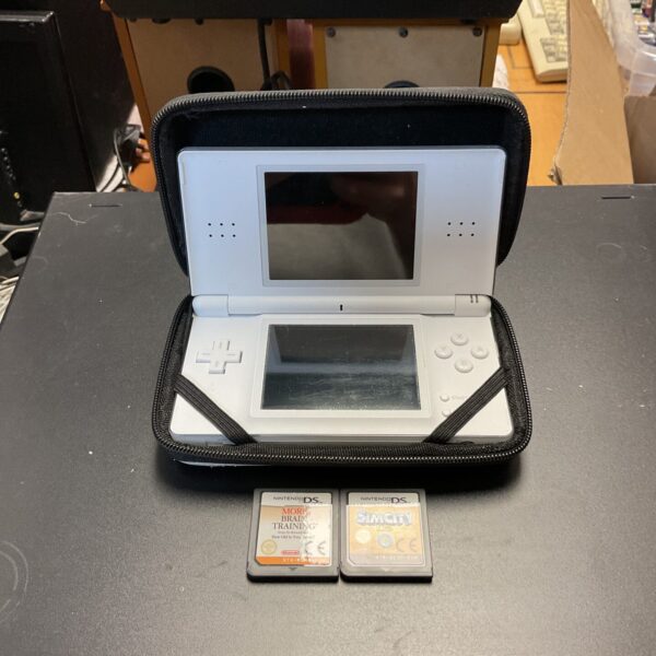 Nintendo DS Lite console with games presented for sale.