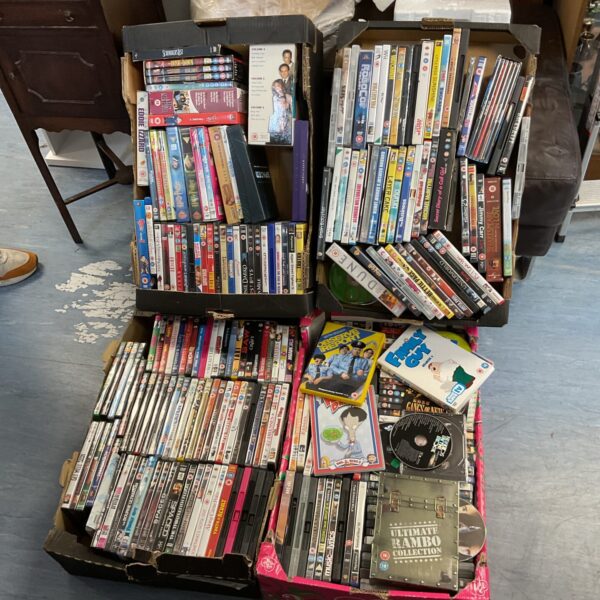 Large lot of DVD movies and box sets in trays.