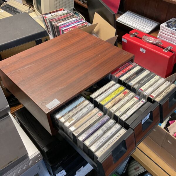 Vintage plastic cassette storage drawers filled with tapes.