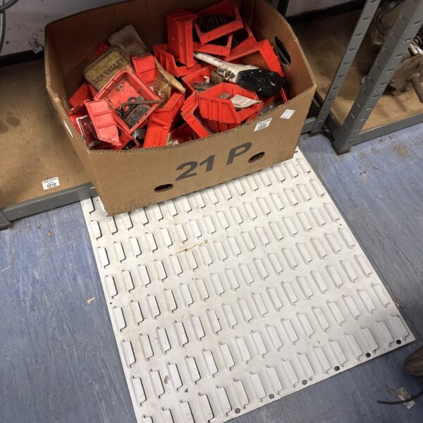 Used wall mounted organiser with plastic storage bins for tools.