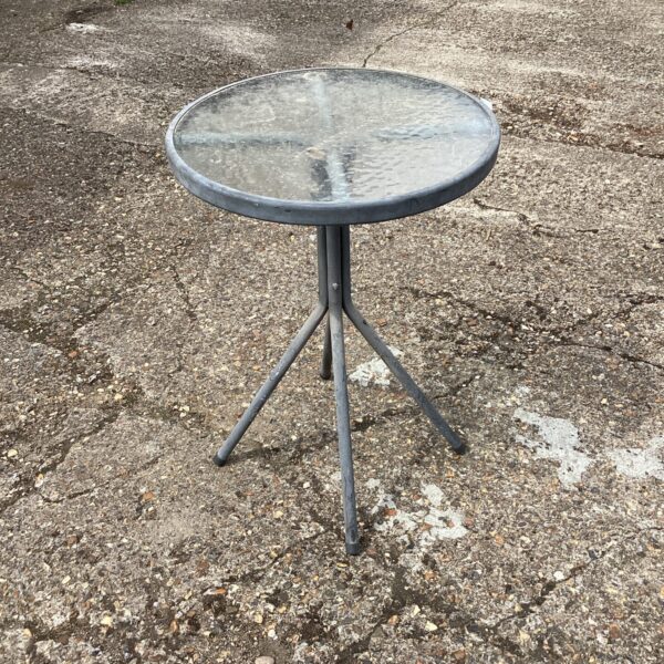 Small garden glass table with metal tripod base.