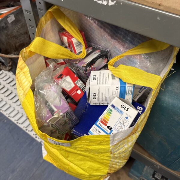 Large bag filled with assorted light bulbs for various uses.