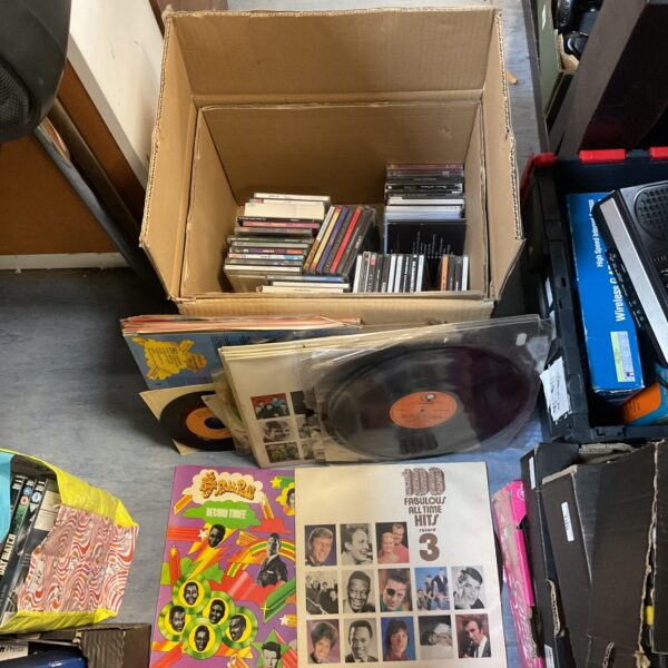Mixed lot of vinyl records and CDs for music lovers.