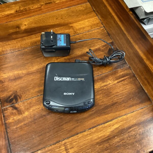 Vintage Sony D-133 Discman portable CD player with charger.
