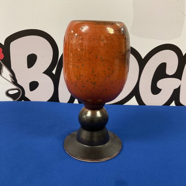 Front view of a signed Nigerian art pottery goblet vase.