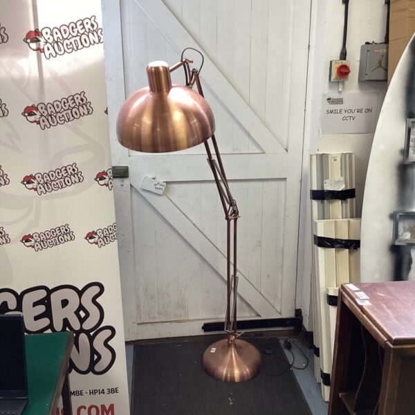 Rose gold floor lamp with adjustable head and stylish design.