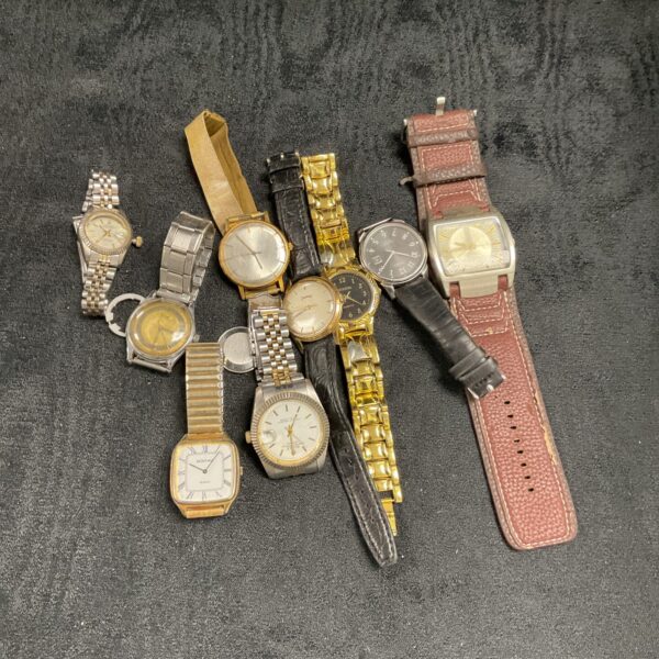 Vintage watch lot for repair and collection, various styles.
