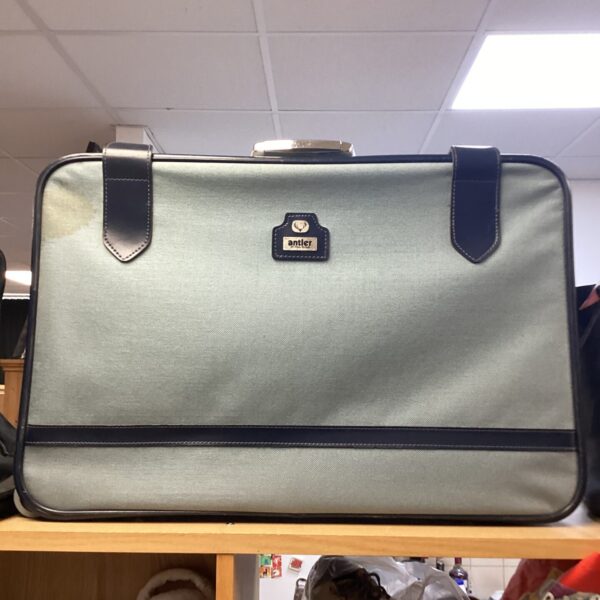 Front view of a vintage Antler suitcase in green.