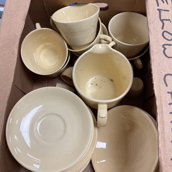 Vintage yellow china tea set with teacups and creamer.