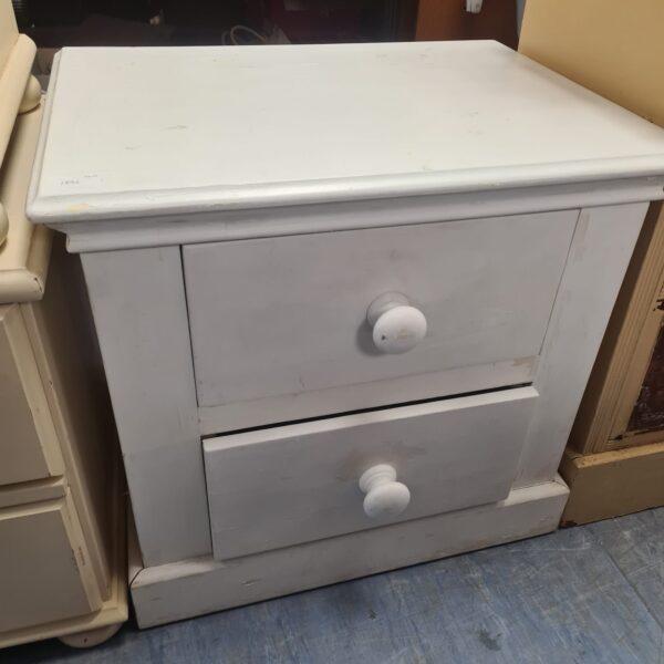 White painted two-drawer bedside table for bedroom storage.