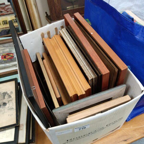 Assorted lot of empty wooden picture frames for crafting.