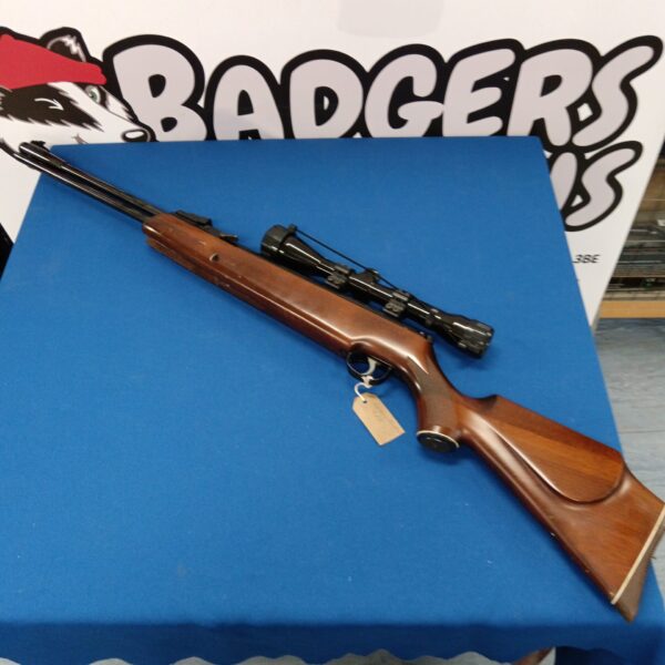 Vintage Webley Eclipse .22 air rifle with scope, side view.