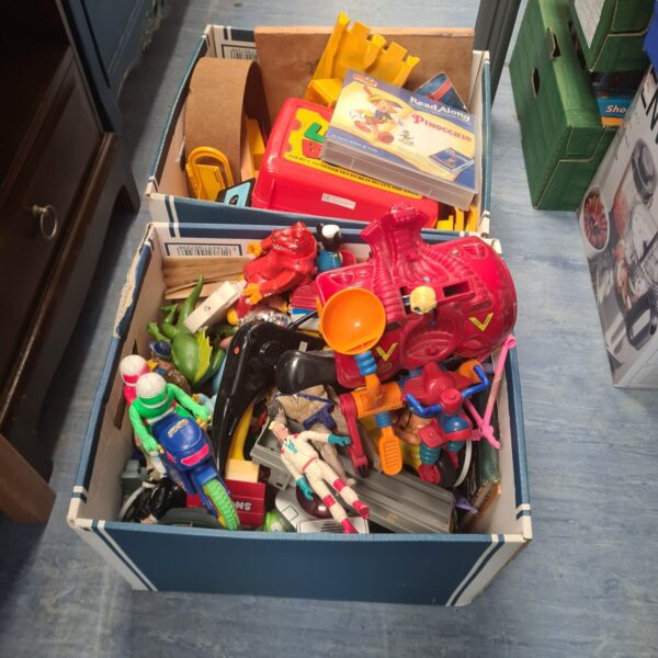 Overview of a vintage 1980s toy lot with various action figures.