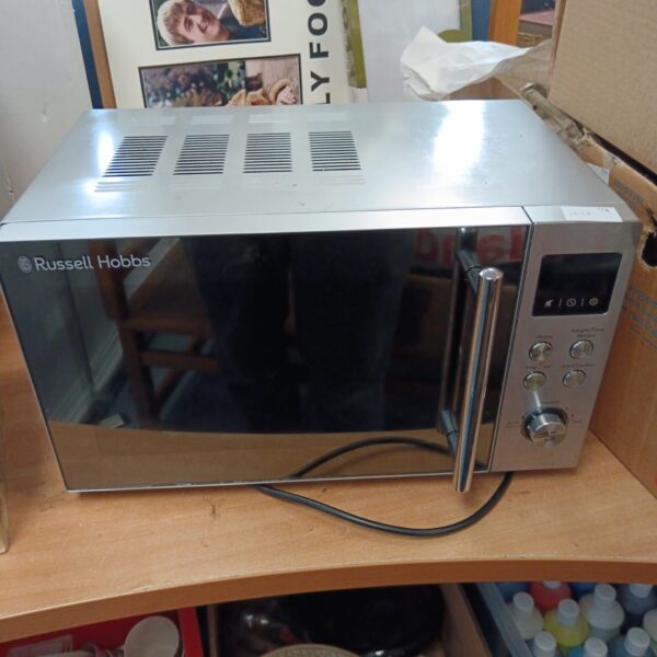 Stainless steel Russell Hobbs microwave oven for kitchen use.