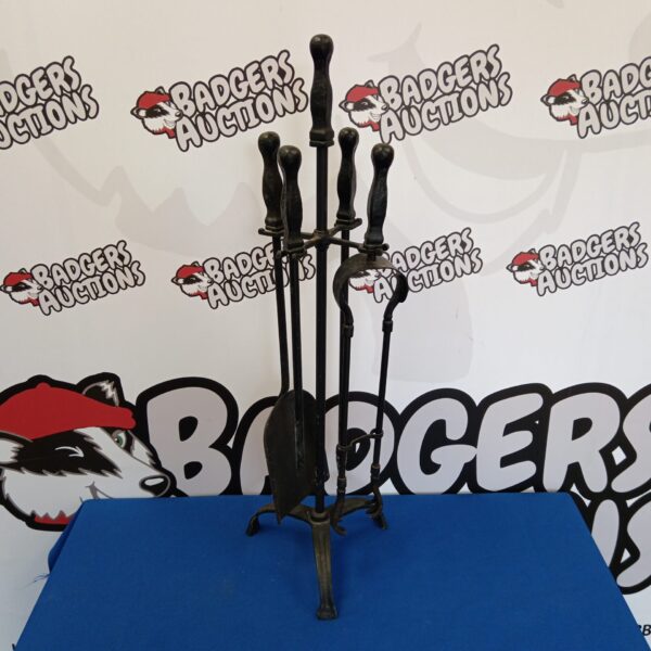 Vintage wrought iron fireplace companion set with decorative handles.