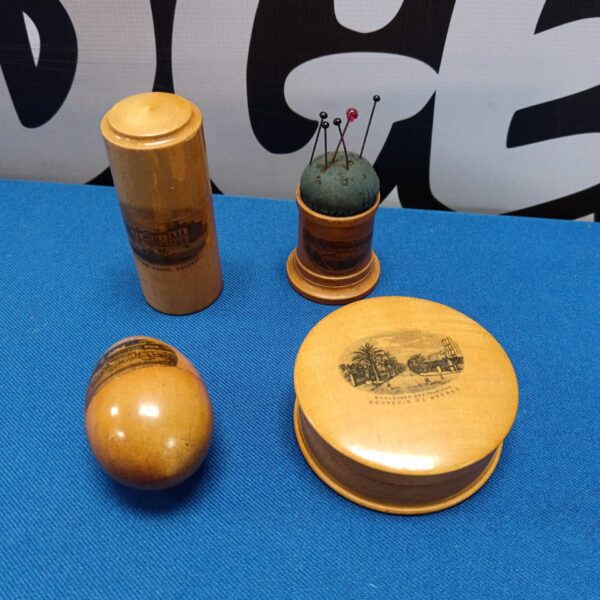Antique Mauchline ware collection featuring a pin cushion and thimble holder.