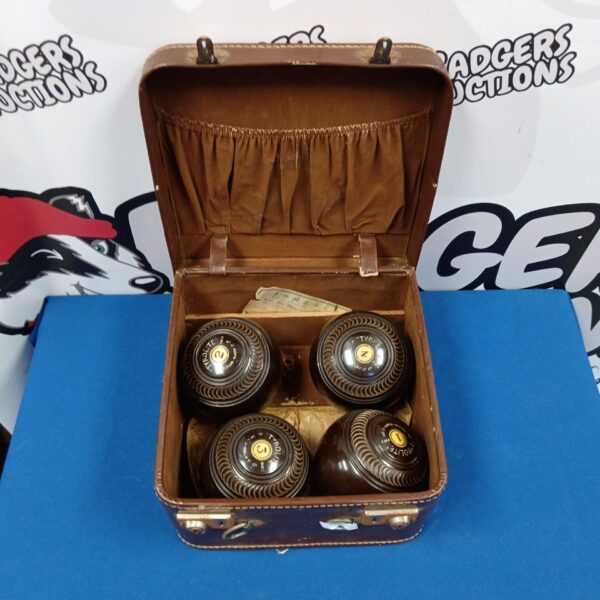 Vintage tyrolite lawn bowls set in original carrying case.