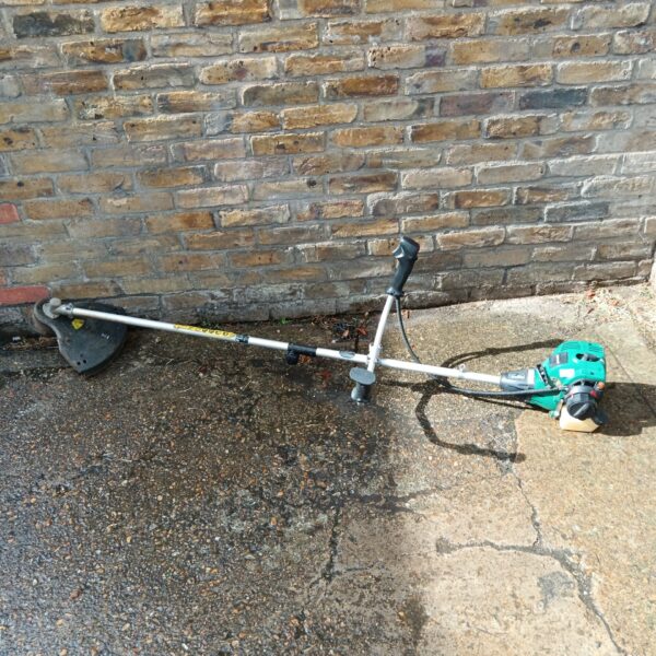 Used Qualcast petrol strimmer for garden maintenance and landscaping.