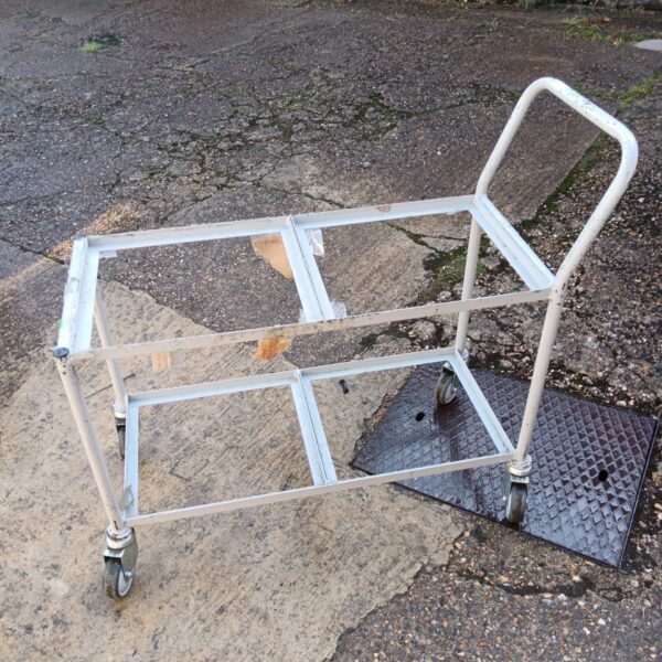 Heavy duty metal trolley with three tiers for utility use.