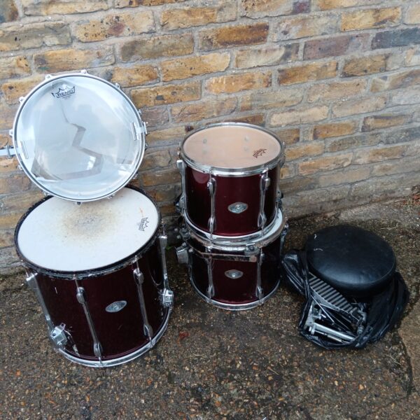 Burgundy Itama drum kit with stool and pedal, awaiting restoration.