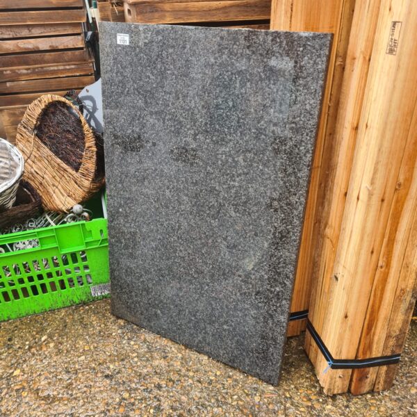 Grey speckled granite worktop slab for kitchen or furniture.
