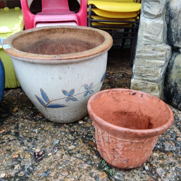 Floral and terracotta plant pots for garden display.