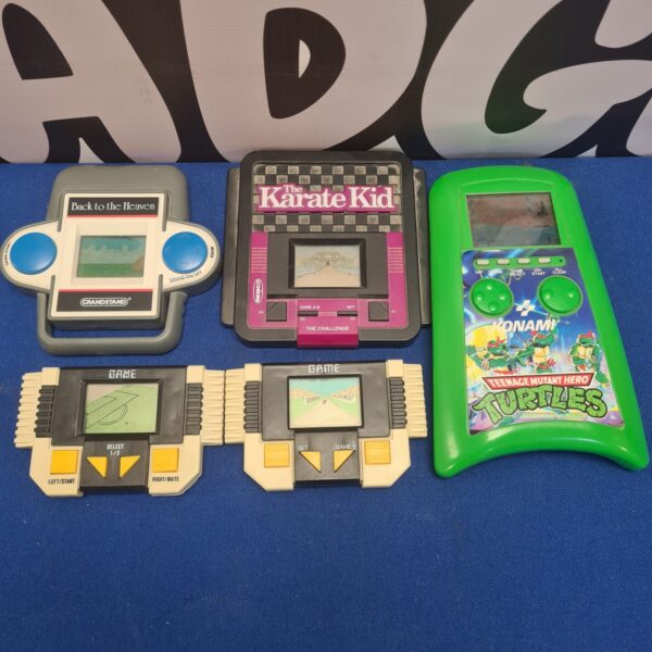 Vintage handheld game consoles lot including Konami and Grandstand.