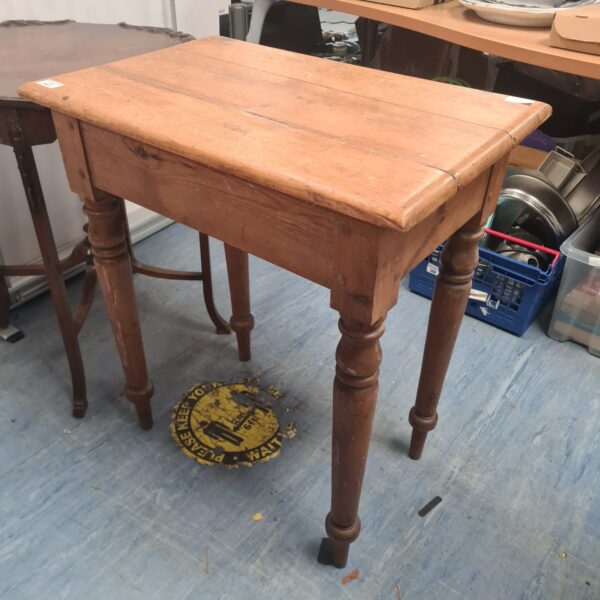 Vintage pine side table with a single drawer and turned legs.
