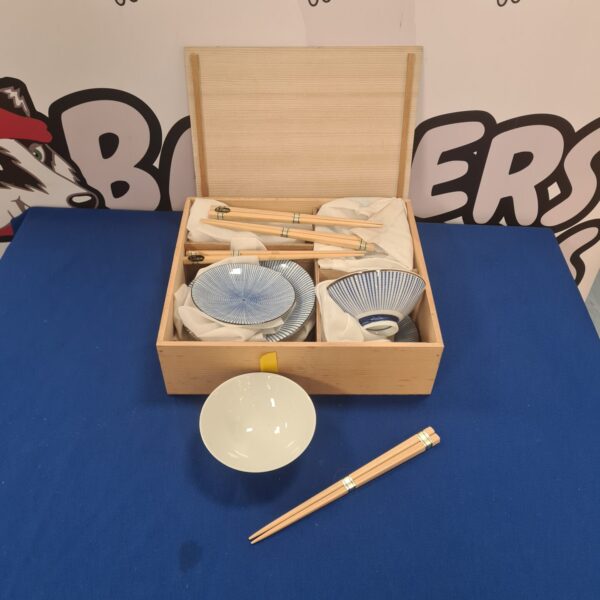 Chinese rice bowls and chopsticks set displayed in a bamboo box.