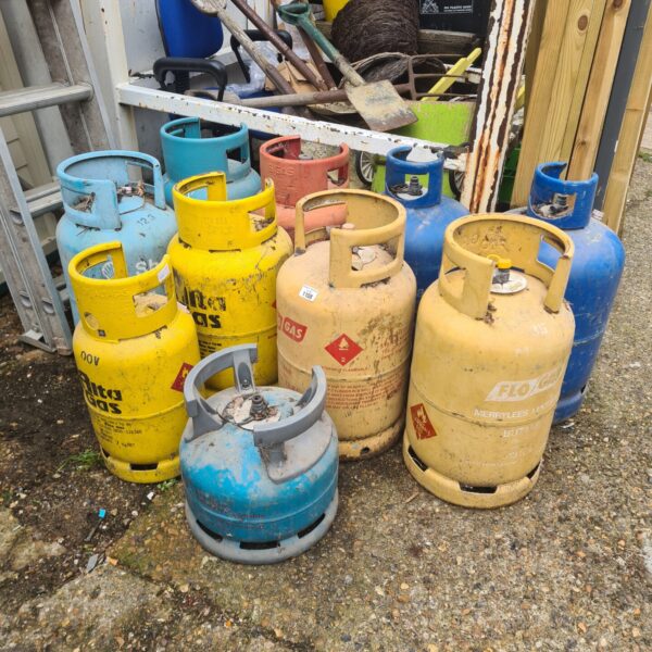 Selection of used gas bottles including Flow Gas cylinders.