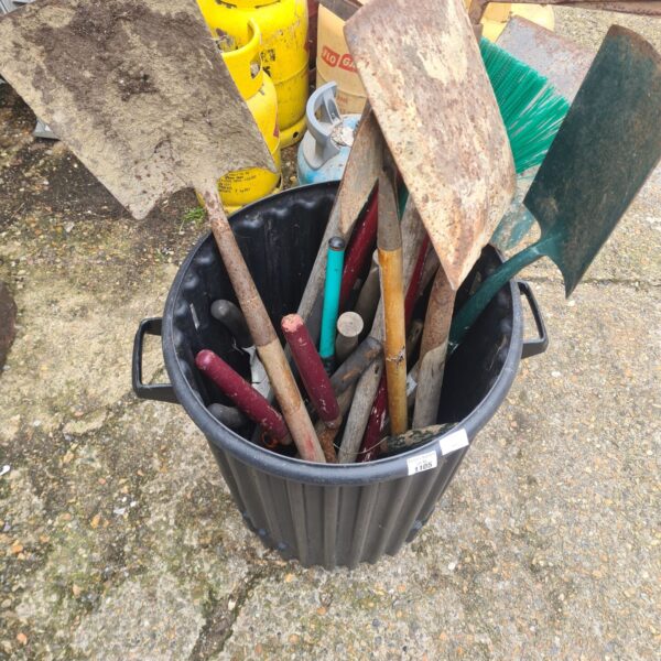 Plastic bin filled with a mixed lot of garden tools and shovels.
