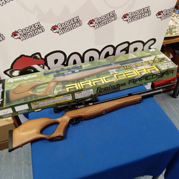 Remington Airacobra pre charged rifle with scope in original box.