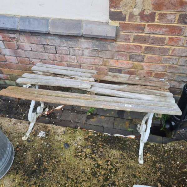 Rustic vintage garden table with cast iron ends for restoration.